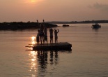 me and the kids silhouetted on a floating dock at sunset